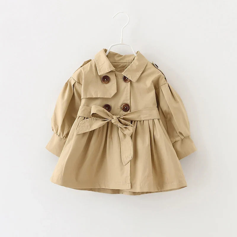 Side view of a girl's pink cotton trench coat, comfortable and fashionable baby outerwear.
