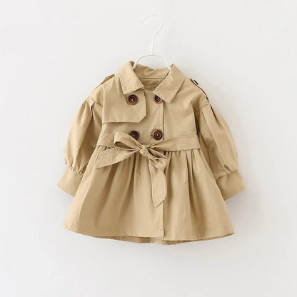 Side view of a girl's pink cotton trench coat, comfortable and fashionable baby outerwear.
