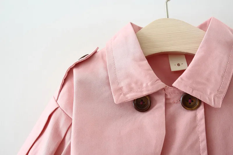 Chic baby girl cotton trench coat in a solid color, perfect for everyday autumn wear.