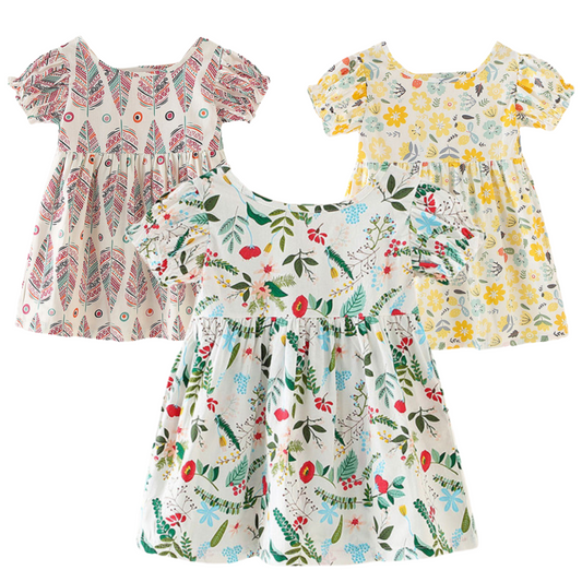 Baby girl wearing a nature pattern puff sleeve sundress, front view, perfect for summer.