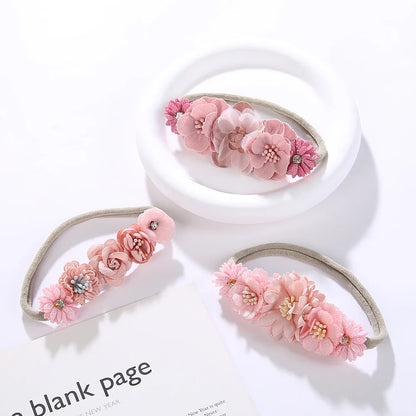 Set of three artificial flower baby headbands with rhinestones, includes pink, white, lavender colors, nylon.
