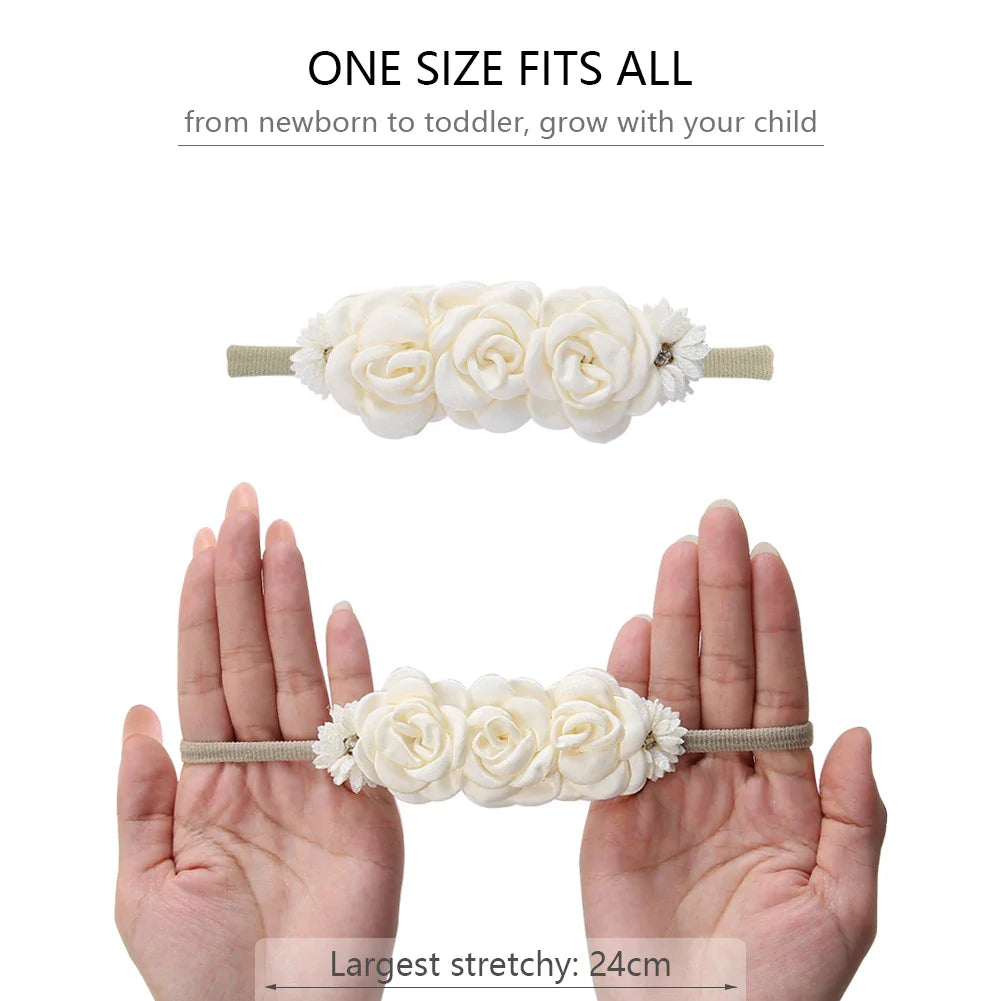Infant girl in a studio, wearing a purple artificial flower headband with rhinestones, perfect photo prop.