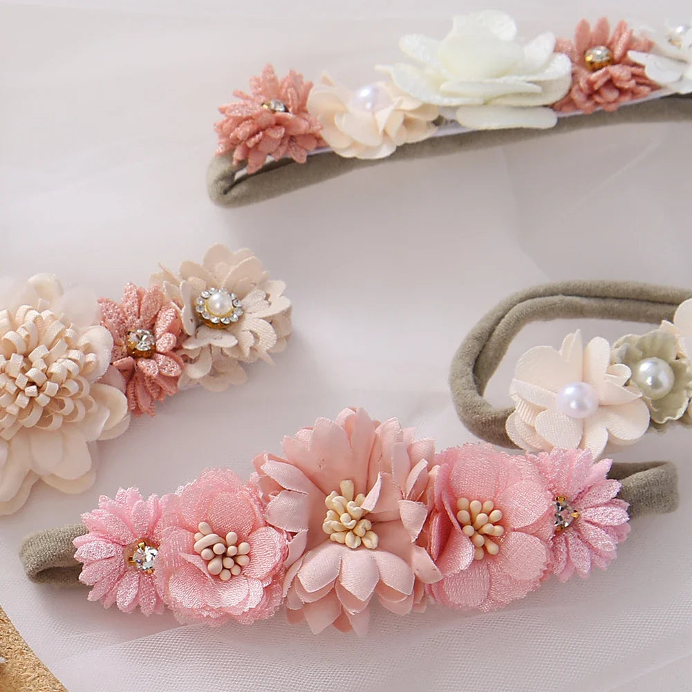 Three baby headbands with artificial flowers & rhinestones displayed, soft nylon, suitable for baby shower gift.