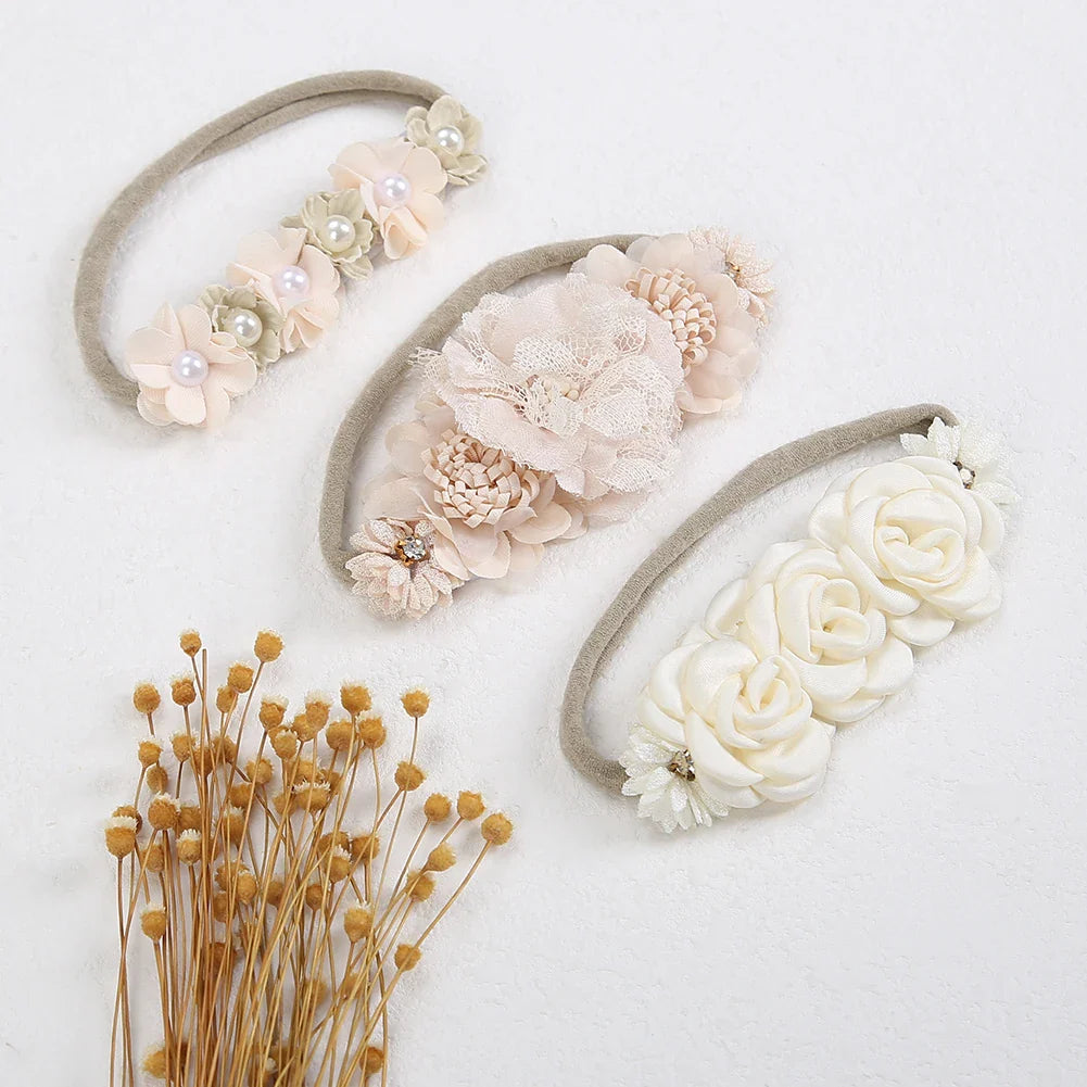 Assorted artificial flower baby headbands with delicate rhinestones, stretchy nylon, for infants & toddlers.