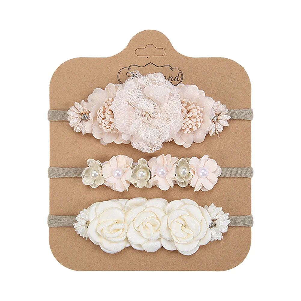 Newborn headwear: white artificial flower headband with shiny rhinestones, gentle nylon elastic, baby accessory.
