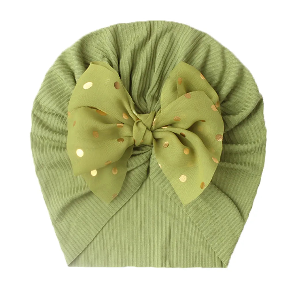 Baby girl's shiny coral bowknot turban hat, comfortable infant accessory.