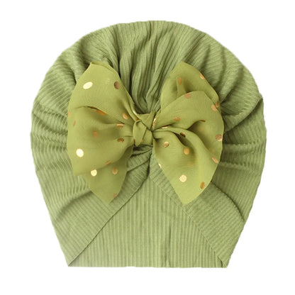 Baby girl's shiny coral bowknot turban hat, comfortable infant accessory.