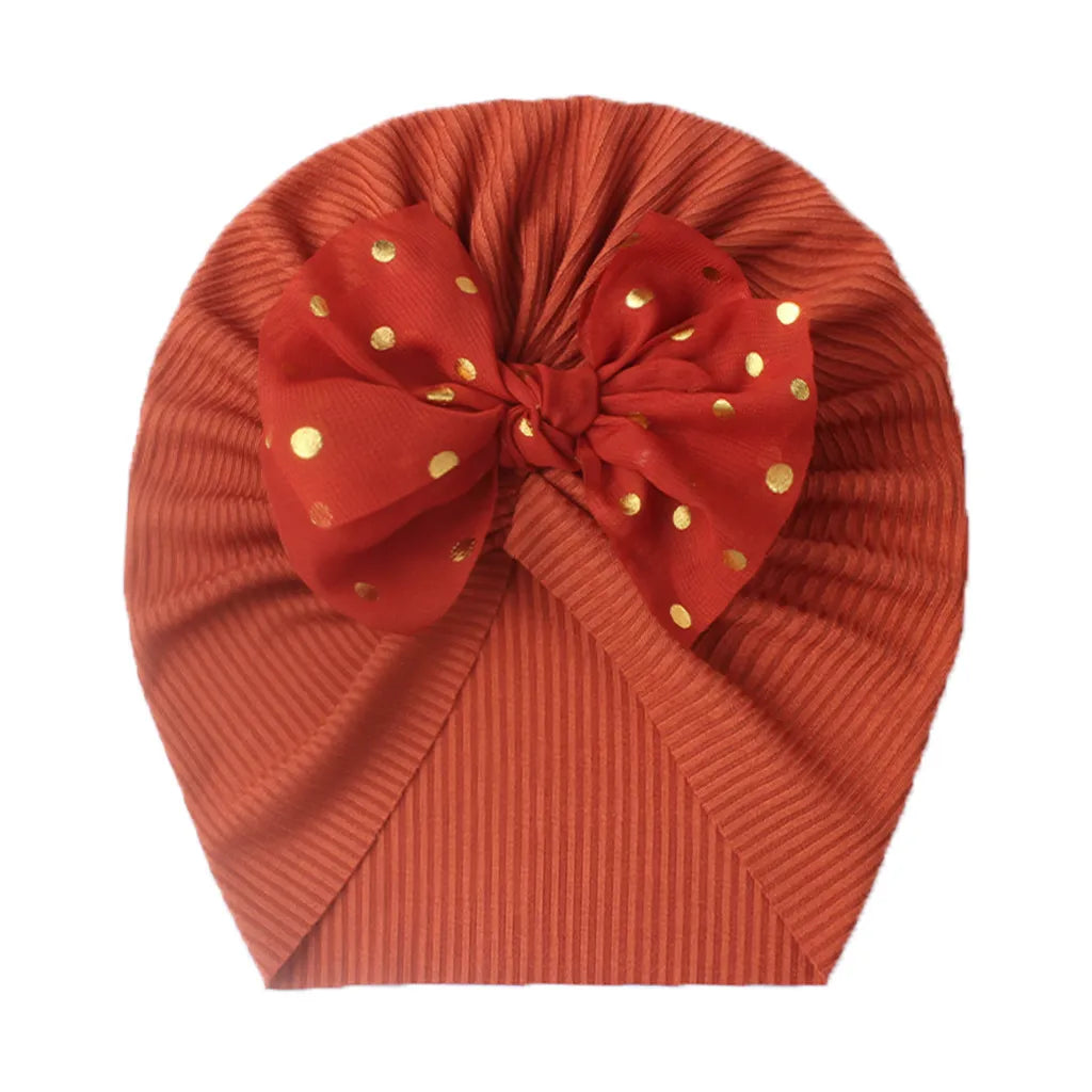 Shiny purple bowknot turban hat for baby girls, stretchable and soft.