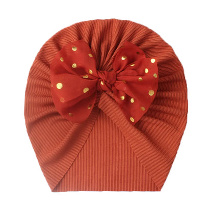 Shiny purple bowknot turban hat for baby girls, stretchable and soft.