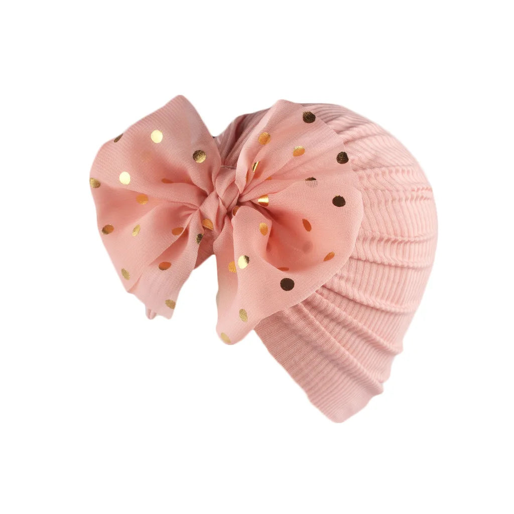 Newborn accessory: a baby girl's sparkling silver bowknot turban hat.