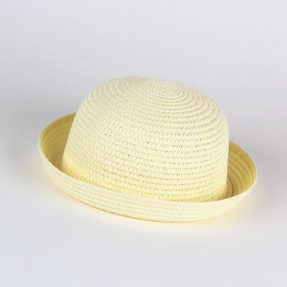 Baby girl wearing a wide brim straw sun hat with flower accent, perfect for summer UV protection.