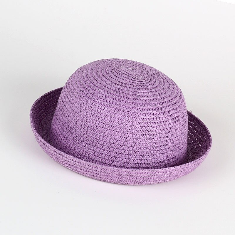 Toddler girl's wide brim straw sun hat, natural woven material, ideal for beach and outdoor play.