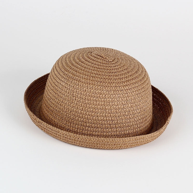 Infant girl's lightweight straw sun hat with a decorative ribbon, essential for summer protection.