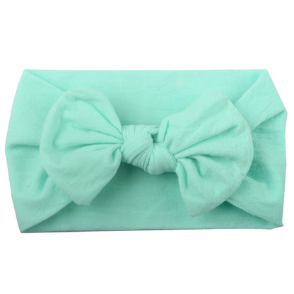 Baby girl sleeping peacefully with a delicate pink bowknot headband, photo prop.