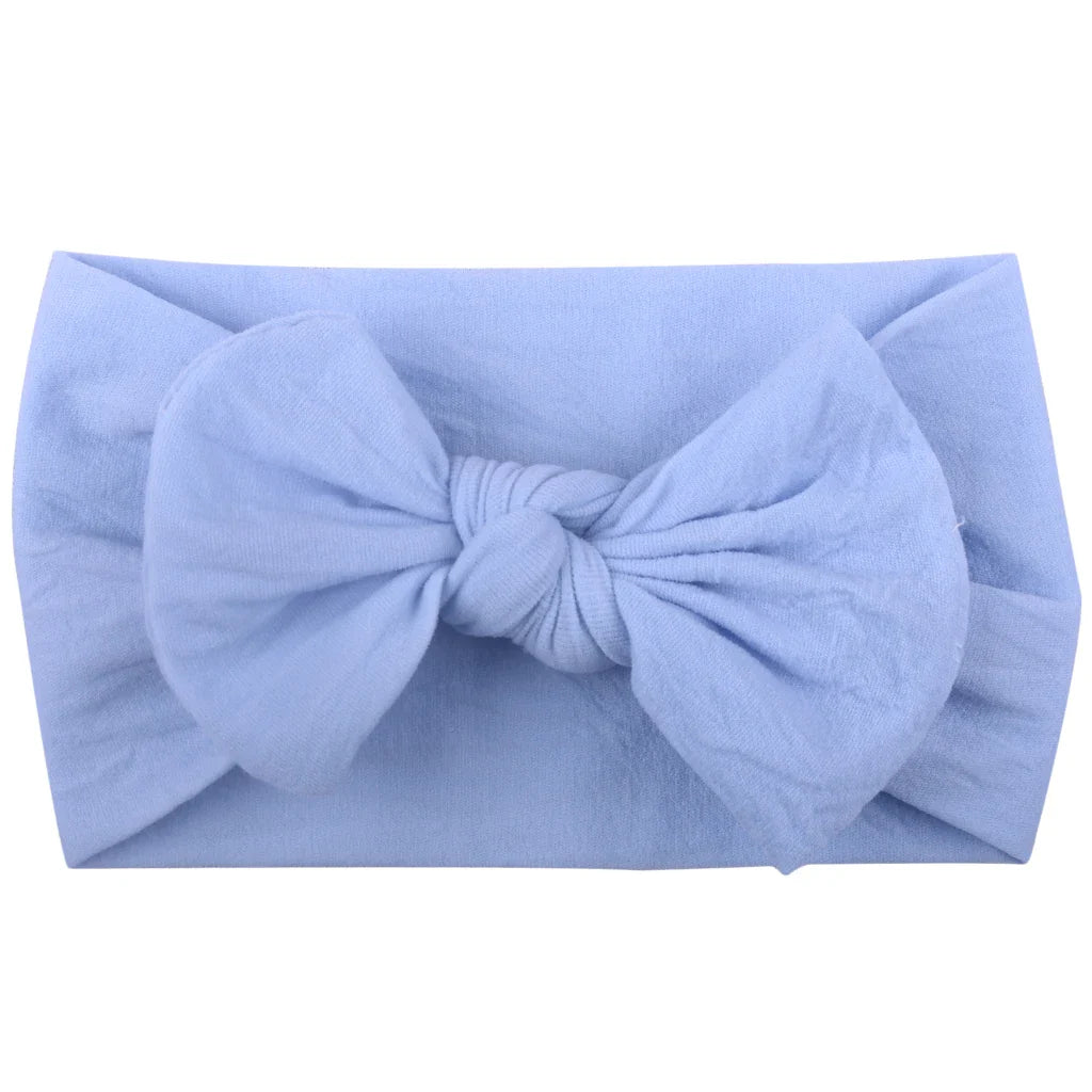 Arrangement of baby girl bowknot headbands, various sizes, elastic and soft for infants.