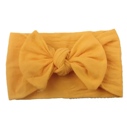 Assortment of baby girl bowknot headbands in various colors, soft elastic for comfort.
