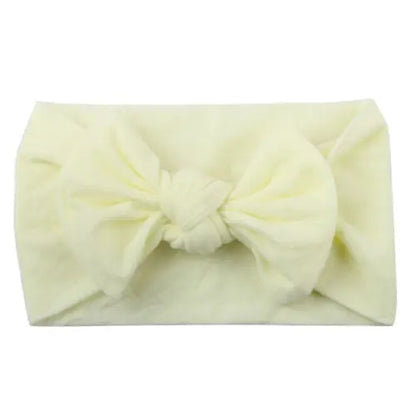Baby girl in a yellow dress with a matching yellow bowknot headband, cute and elastic.