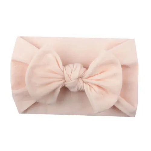 Close up of fine details on a baby bowknot headband, showing soft elastic fabric.