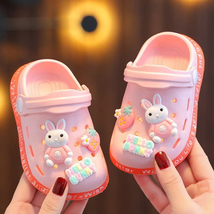 Baby girl wearing pink non-slip soft sandals with adjustable strap, perfect for summer beach play.