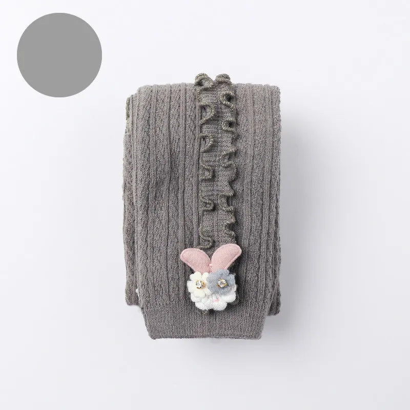 Girl's cozy cotton ribbed tights in a neutral grey, versatile for any baby outfit.