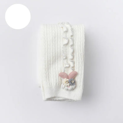 Baby girl fashion: ribbed cotton tights paired with a dress, for a stylish infant look.