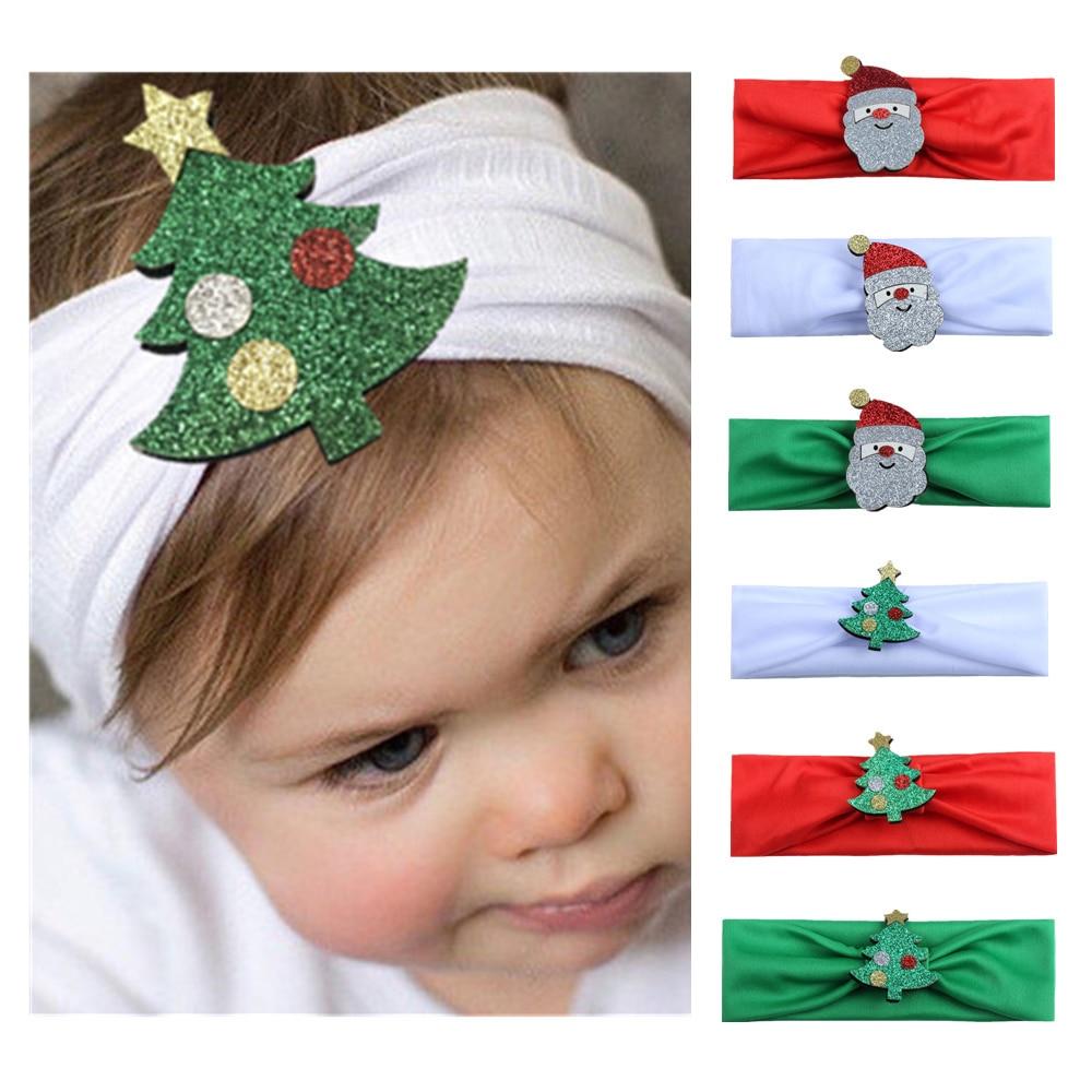 Baby girl wearing red Christmas festive headband with Santa Claus hat, perfect holiday accessory