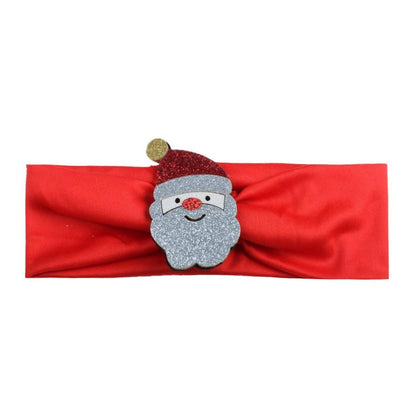 Toddler girl smiling while wearing a sparkly Christmas festive headband with holiday embellishments