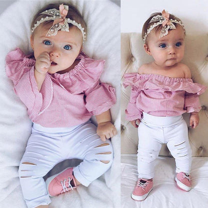 Baby girl wearing striped Bardot top with ruffled sleeves and ripped jeans, infant summer fashion set