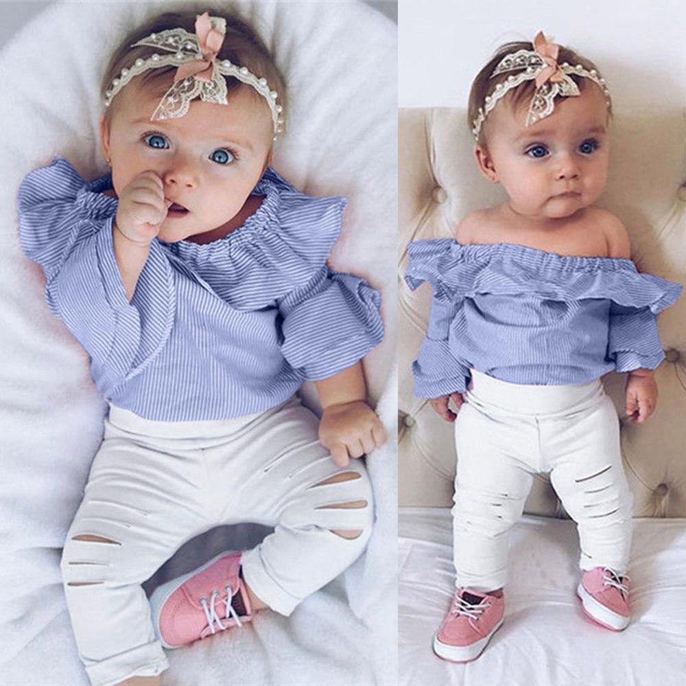 Close-up of a baby girl striped Bardot top with off-shoulder design and ruffled trims, cotton blend