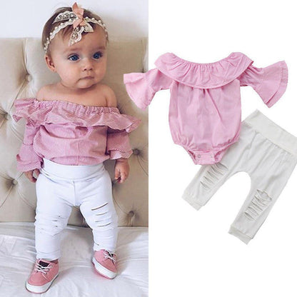 Full shot of a baby girl's outfit: striped Bardot top and stylish ripped jeans, infant clothing set