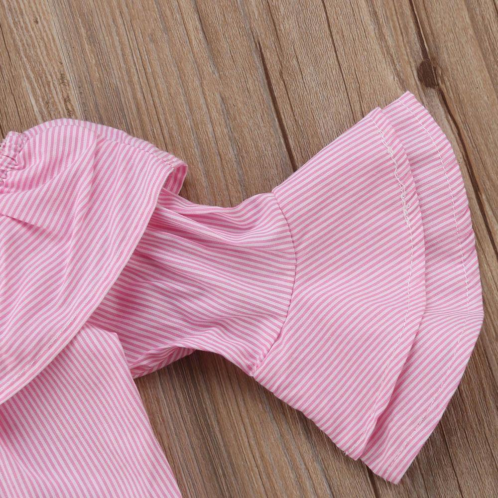 Detail of baby girl's ripped jeans with distressed knees, perfect for an active infant's style