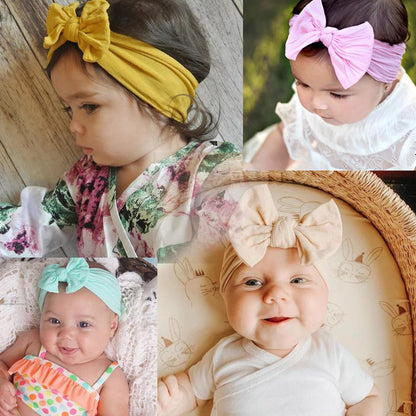 Close-up of pink soft elastic baby headband with bow, newborn girls' fashion accessory
