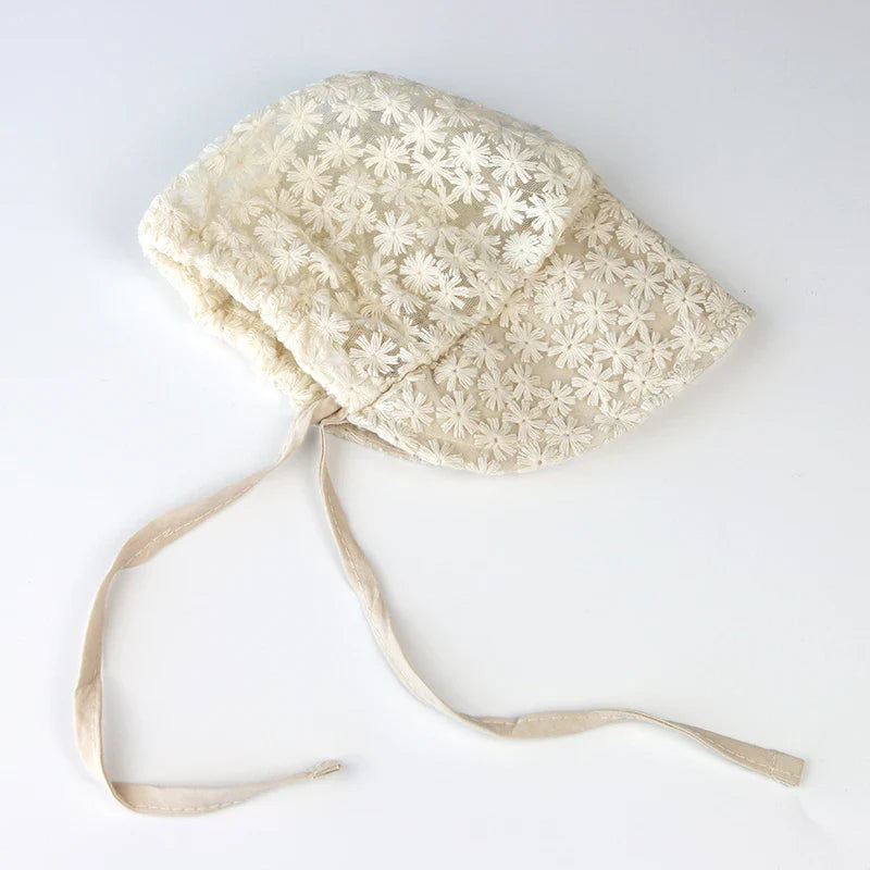 Cute beige baby hat with lace flowers, perfect for keeping baby girls shaded and stylish in summer