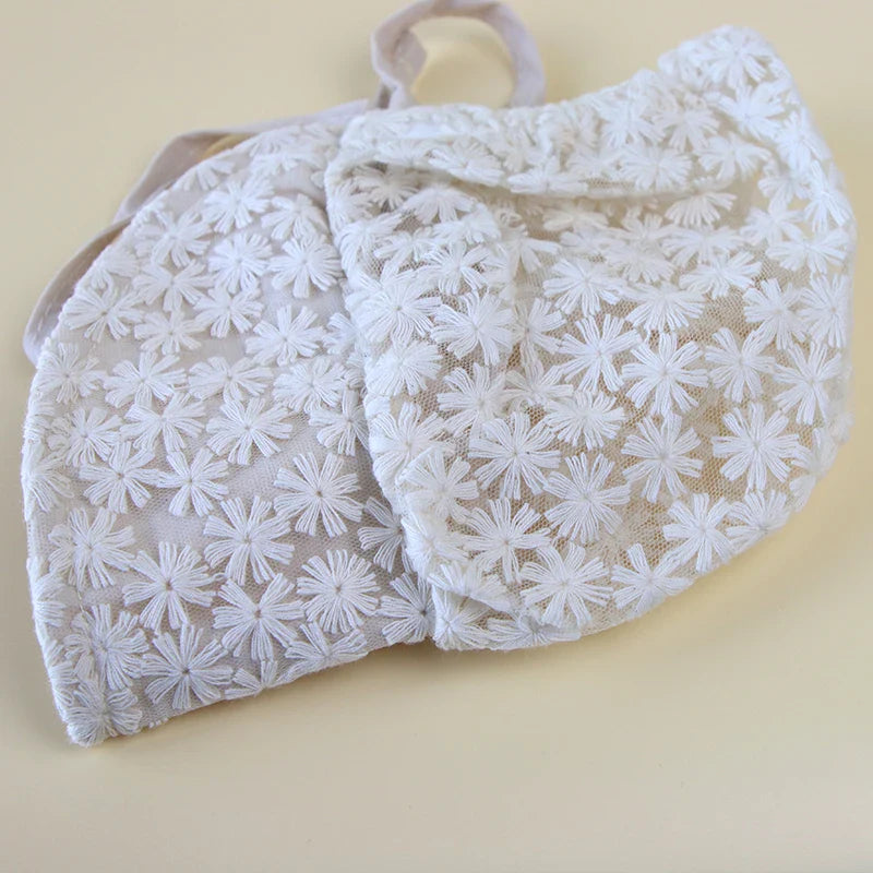 Baby girls sun hat with an all-over lace flower design, offering sweet and chic sun protection