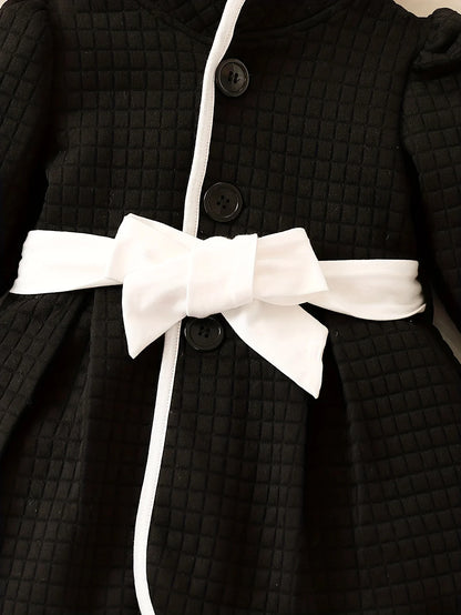 Close-up of puff sleeve on baby girls' thermal dress top, black and white, cozy winter outfit detail
