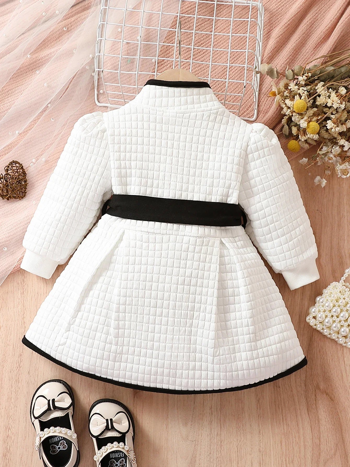 Toddler girl wearing black and white thermal belted dress set, cozy puff sleeve top, winter fashion