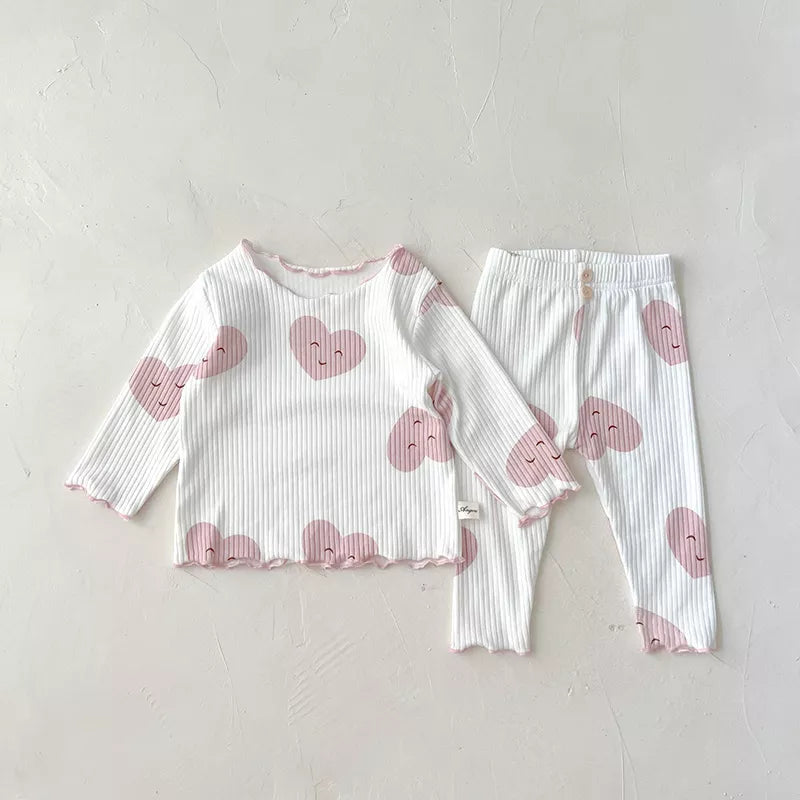 Close-up of soft cotton fabric from a dot print baby girl sleeper set, showing detail