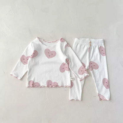 Close-up of soft cotton fabric from a dot print baby girl sleeper set, showing detail