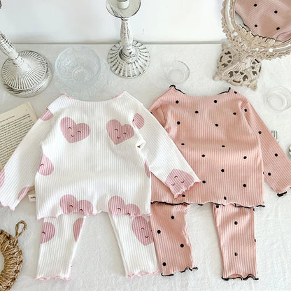 Close-up of soft cotton sleeper set with delicate dot print for baby girls' cozy wear