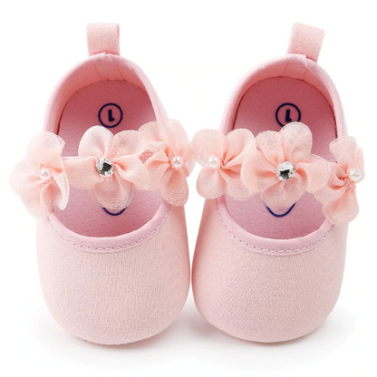 Close-up of pink floral cotton baby shoes with elastic ankle and matching floral headband set