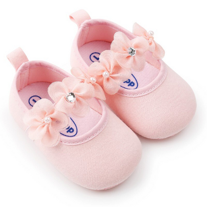 Newborn girl's soft sole cotton pre-walker shoes in a charming floral print with bow headband