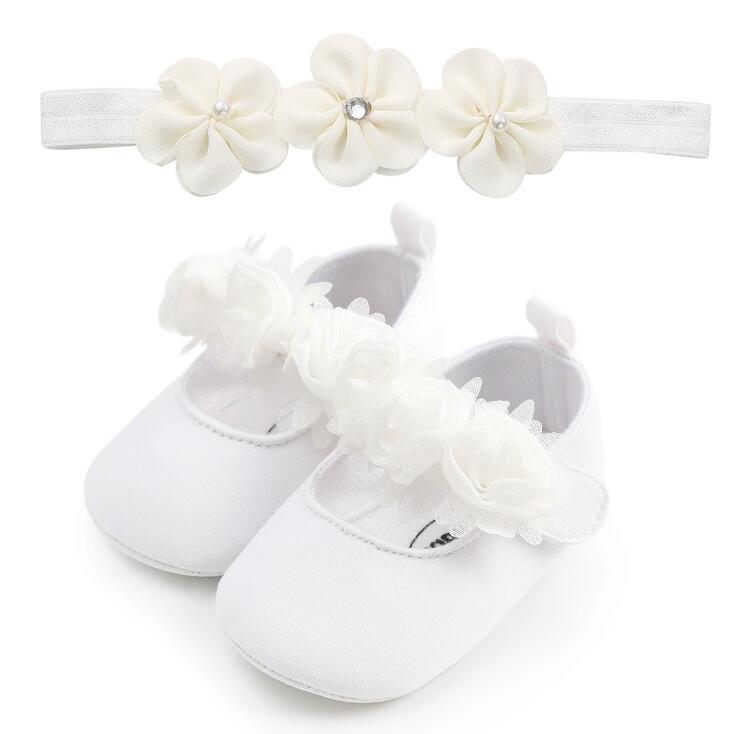 Infant fashion: set of floral cotton pre-walker shoes and a comfortable elastic headband for baby girls