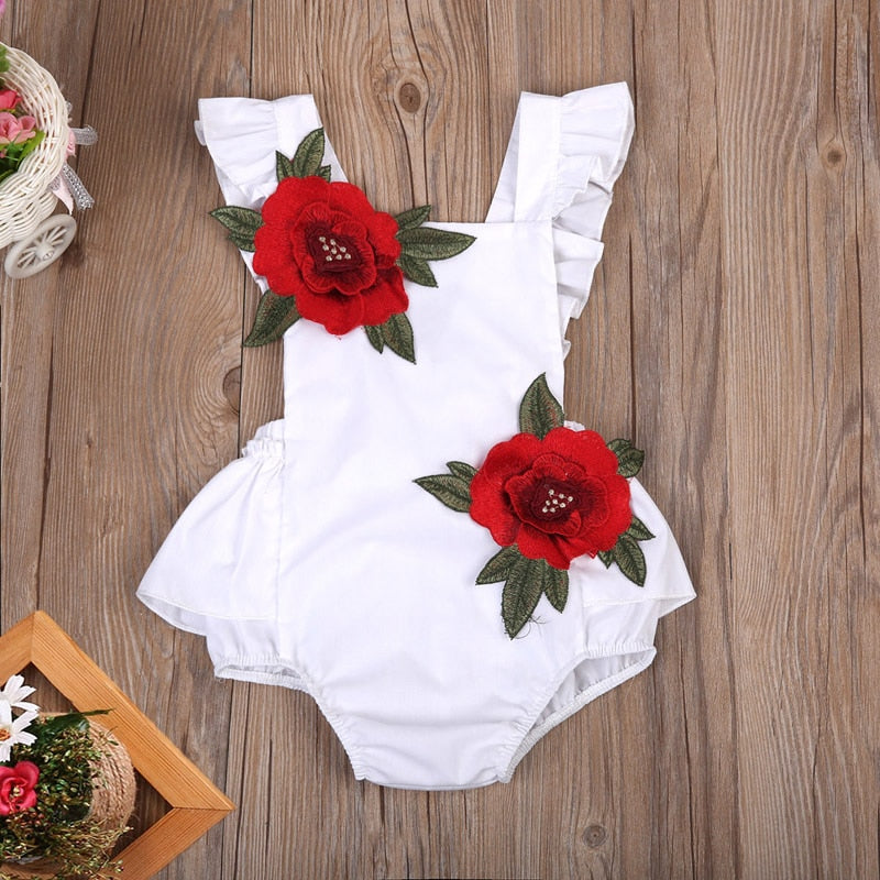 Infant girls' summer romper with colorful floral print and short sleeves.