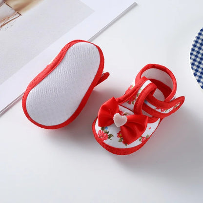 Pink baby girl first walker shoes, non-slip, with bow tie design, soft sole, and secure hook and loop
