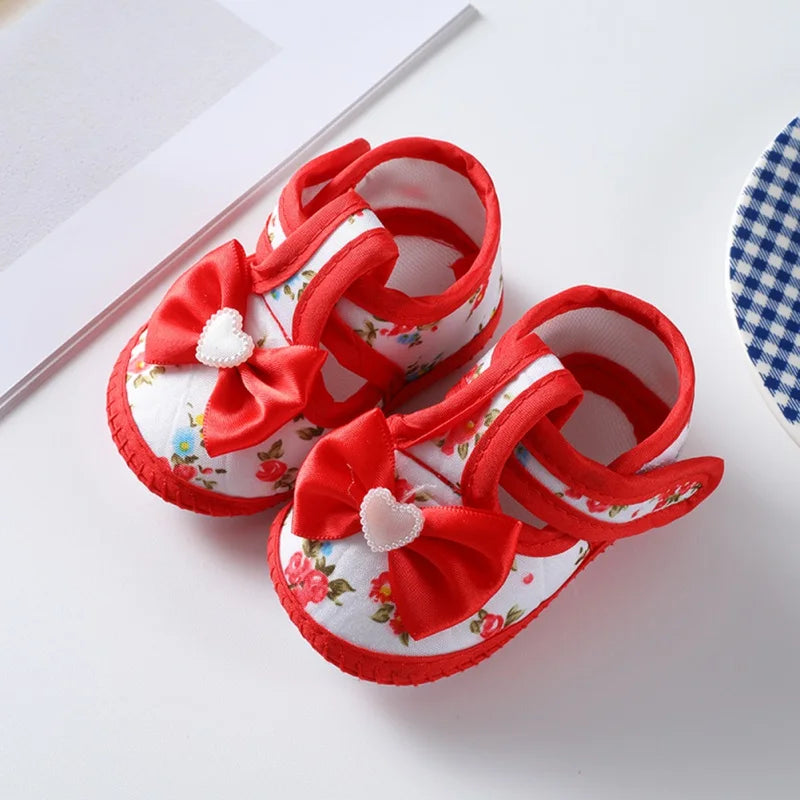 Pink baby girl first walker shoes, non-slip, with flexible soft sole and a decorative bow-tie accent