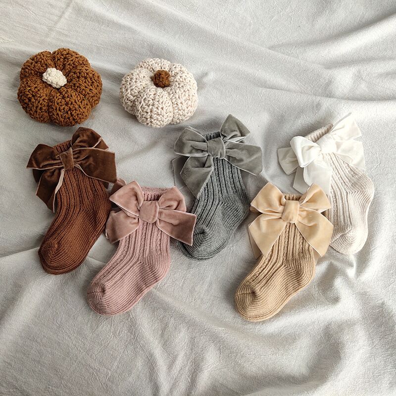 Baby girls' pink ankle socks with a large decorative bow, warm cotton blend, infant sizes, cute baby fashion.