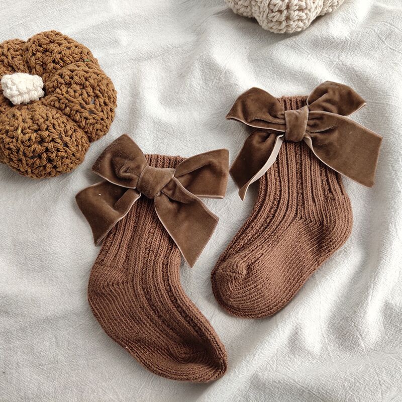Collection of colorful baby girl ankle socks, large bows on the back, warm and durable cotton, perfect for everyday wear.