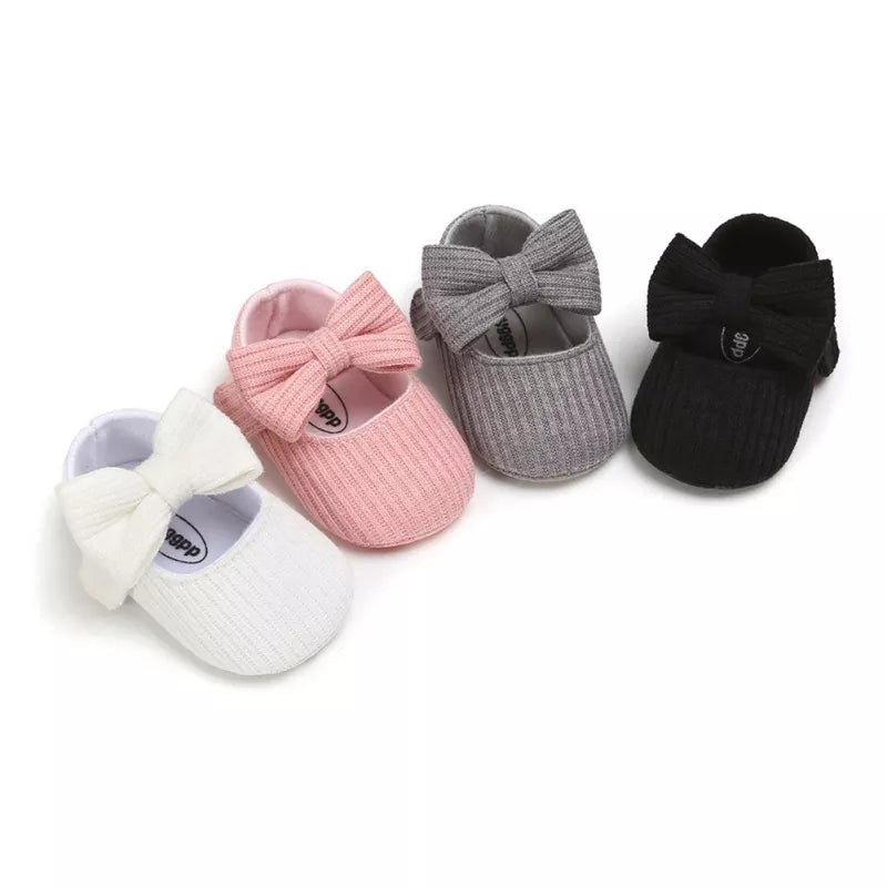 Anti-slip baby girl's sneakers, cream color with a large elegant bow and soft sole.