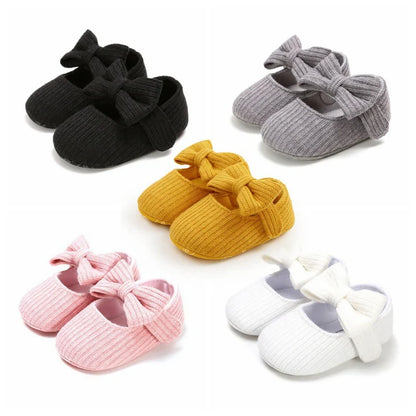 Infant footwear: Navy anti-slip soft sole sneakers for girls, adorned with a bow.