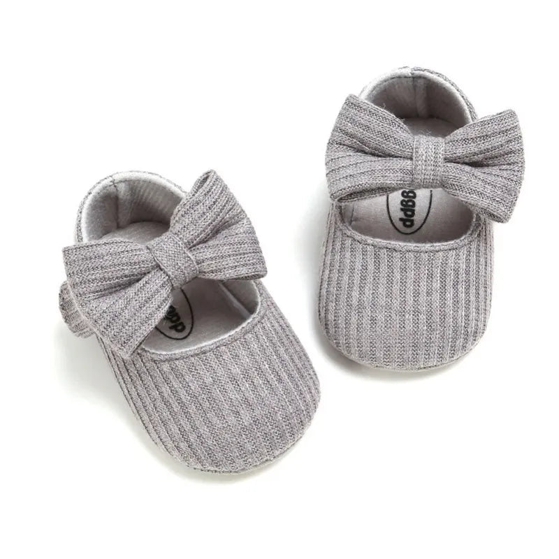 Baby shoes: Blue anti-slip soft sole sneakers with a simple, chic bow for girls.